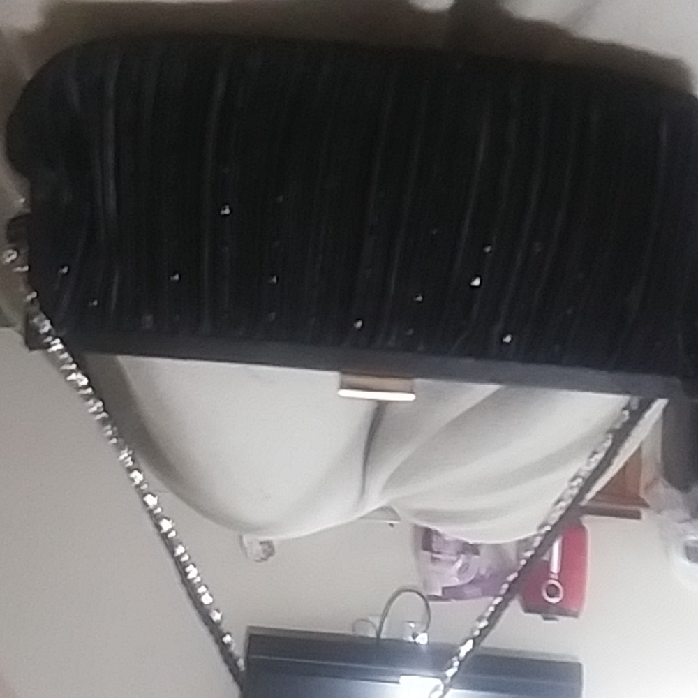 A black wallet/purse with chain like handle with black handle  Also brand new